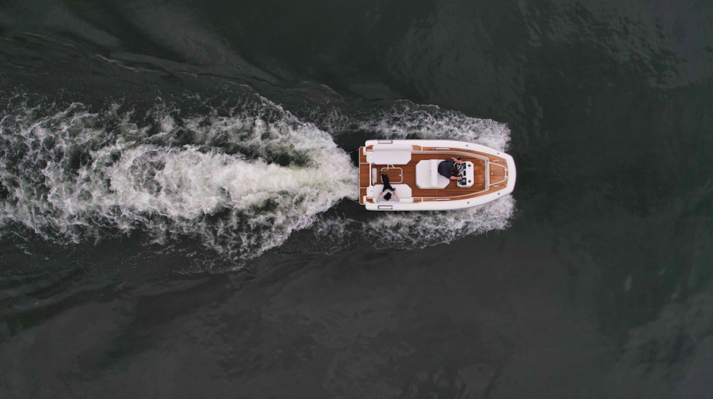 Aerial view of Interior of Agilis Jettender 500D as it powers through water leaving wake