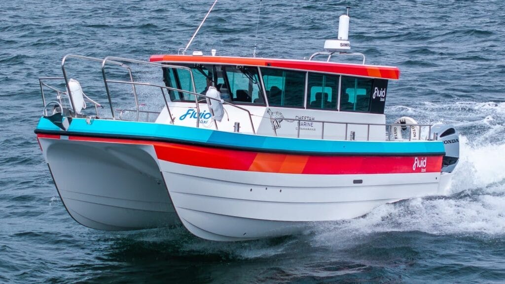 bow on shot of white hulled workboat with red stripe