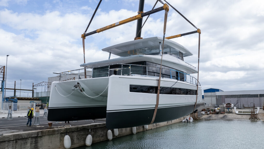 white catamaran being launched