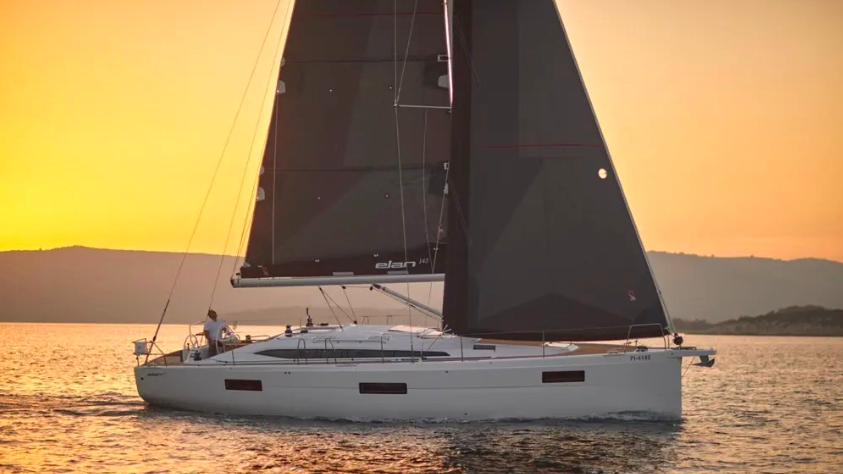 Elan Impression 43 sails in orange sunset