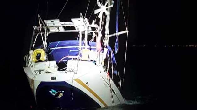 yacht's stern above the water as it sinks. Owner says orca orchestrated attack