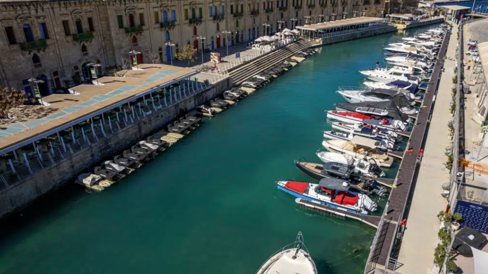 Speed and day boats lined up in a marina - aerial view of boat share club