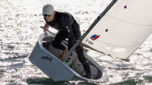 Man sailing on an Optimist - a small, single-handed sailing dinghy