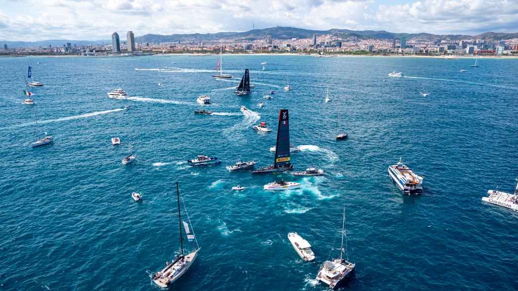 Overhead view of fleet of support and media boats surrounding America's Cup team vying to become challenger