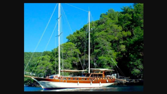 Boat at anchor under azure sky. This is one of Boatsy's yacht rentals available in boat tourism boom