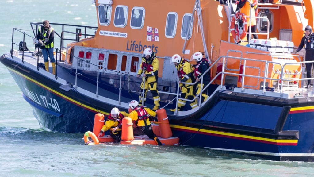 Mass rescue training event in Poole Bay, Dorset on 20the April 2023. Mass simulation event testing of self rescue equipment during a mass rescue in response to the rescue of migrants crossing the English Channel. RNLI lifeguards acted as casualties and were rescued by volunteer crew members by a Shannon, Severn and Atlantic 85 B-class inshore lifeboat.