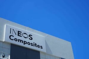 Factory hanger with blue sky above. Factory shows Ineos Composites signage