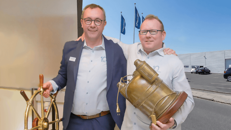 Two men, holding assorted nautical items, smile at the camera in front of a presentation. They're both from EPTechnologies.