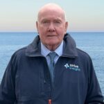 man standing in front of the sea