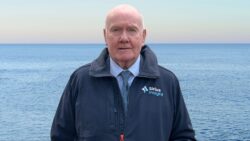 man standing in front of the sea