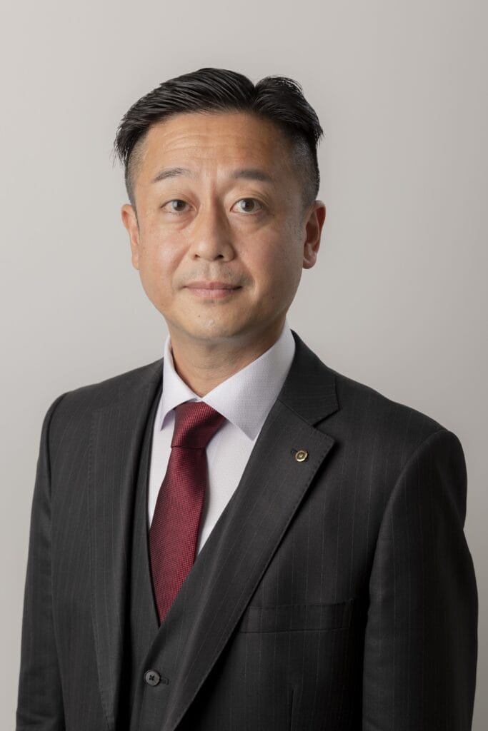 Man in suit looks at camera. This is Masuda Kazuaki from Nippon Technologies