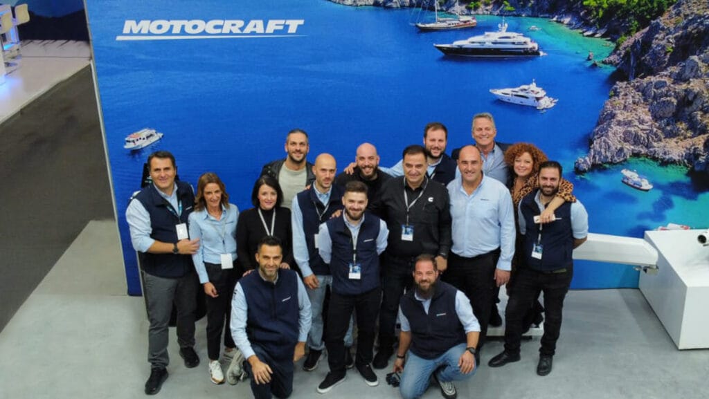 Motocraft team against blue backdrop.