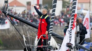 pip hare, women sailor on bow of sailing boat with crowds in background