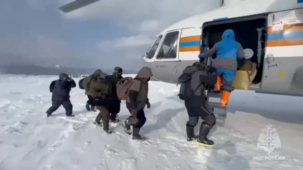 Stranded fishermen board a helicopter during a rescue in Russia’s Sakhalin region.