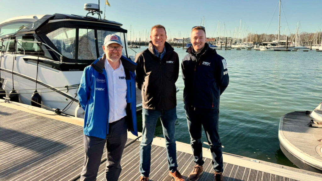 Three men on a dock in front of a boat. This is the top team with Shock WBV