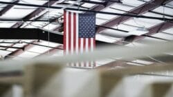 USA flag hangs from factory roof.