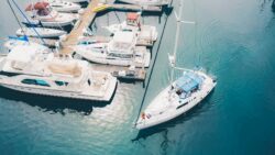 A boat sails out of a marina