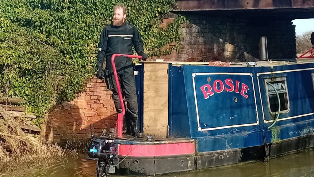 Narrowboat in water after being scuppered by thieves - heads for inspections and repairs