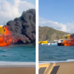 Catamaran boat on fire in Colombia. flames and smoke billow into air as tourists abandon ship and jump into water