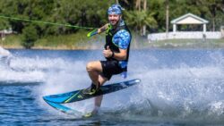 Man wakeboarding and doing thumbs up