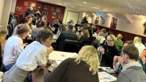 people in conference room around tables