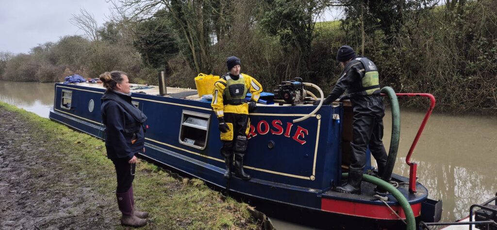 Narrowboat in water after being scuppered by thieves - alongside bank after being raised