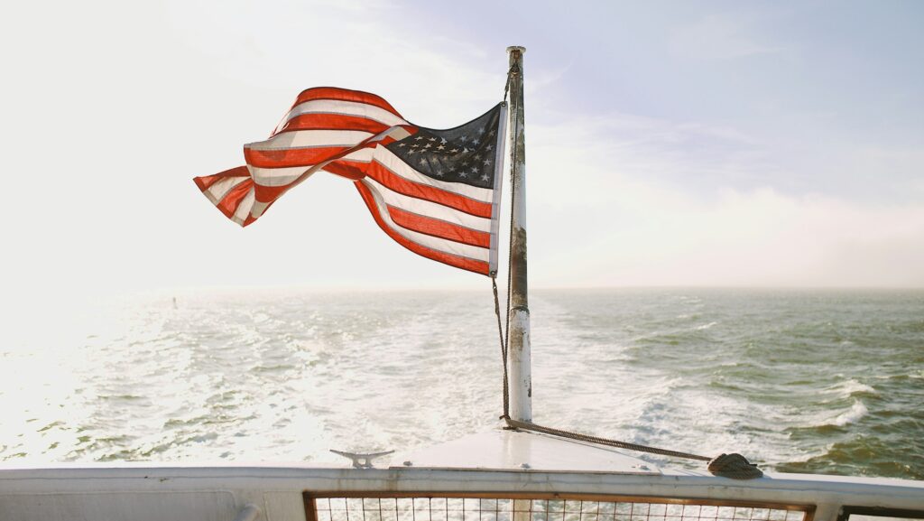 USA flag flies near ocean