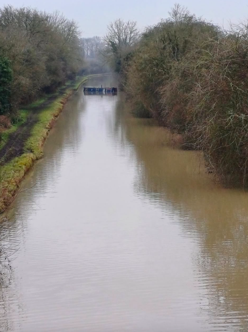 Narrowboat in water after being scuppered by thieves - blocking canal