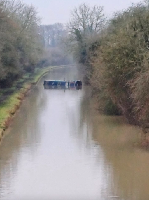 Narrowboat in water after being scuppered by thieves - blocking access