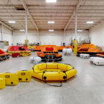 Liferafts are pat of Lalizas safety range. A warehouse of yellow and orange liferafts.