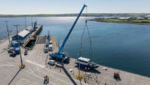 Electric hydrofoil 20ft boat on harbour wall in Orkney