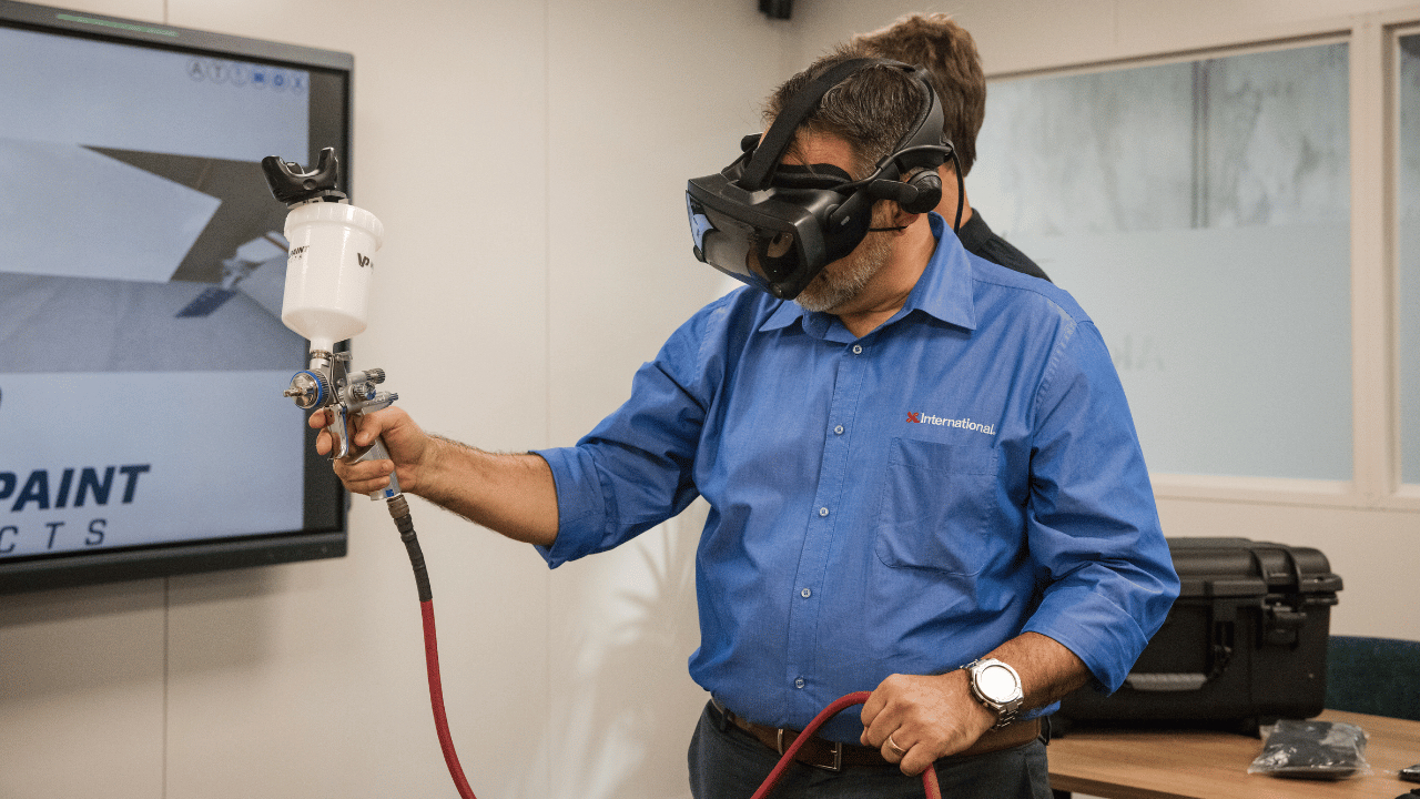 Man in blue shirt demonstrates one of AkzoNobel's digital tools used for AI training