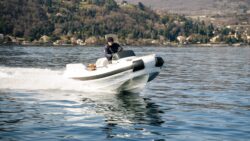 Man drives Castoldi Jet Tender 17 across water in front of Italian landscape