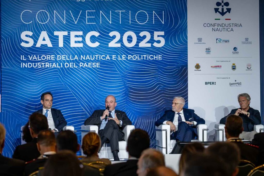 Four men in front of blue conference set