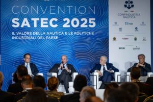 Four men in front of blue conference set