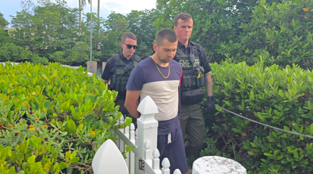Russian man being taken by police after stealing a yacht