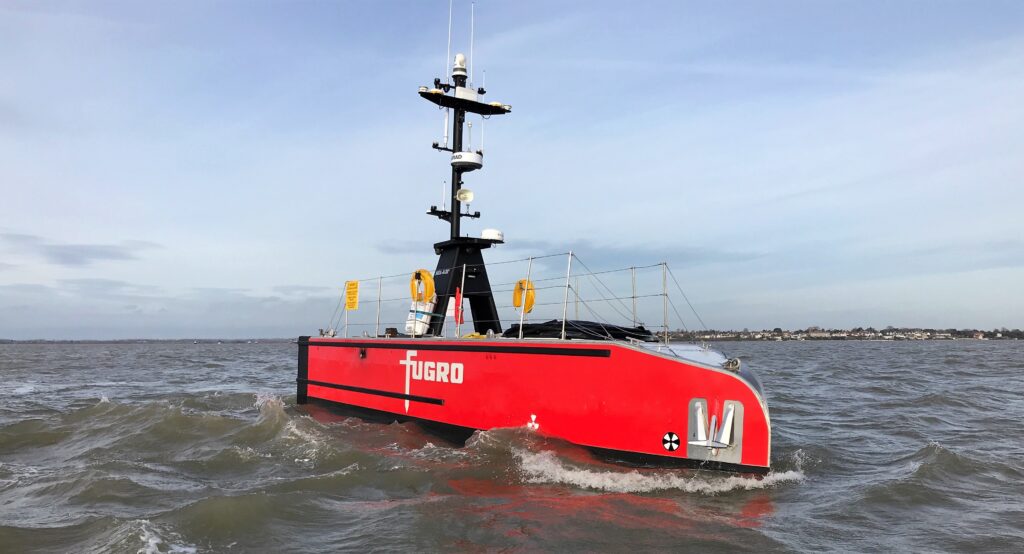 An uncrewed surface vessel travels across the sea in safety