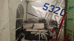 old sails rolled up in a pile ay OneSails GBR South to be recycled and put to new use