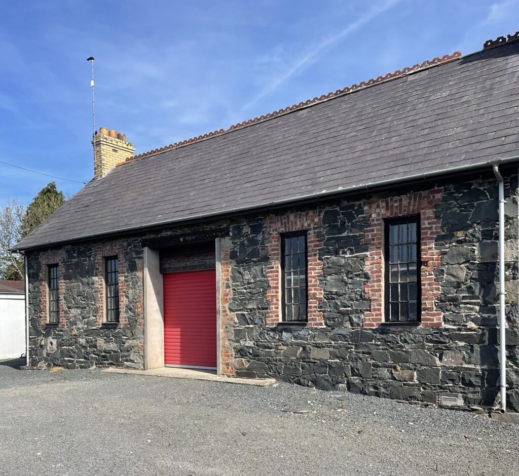 Old school building with red door npw used to make Spiroll in N. Ireland
