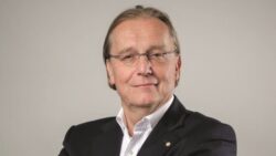 head shot of blonde male with glasses