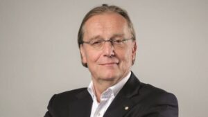head shot of blonde male with glasses