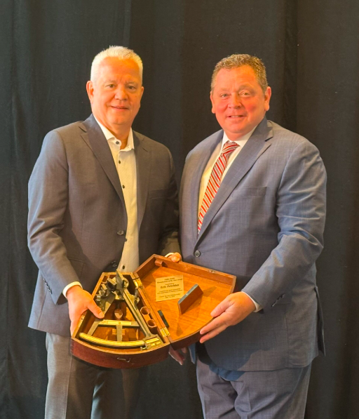 two men in suits holding rather large award