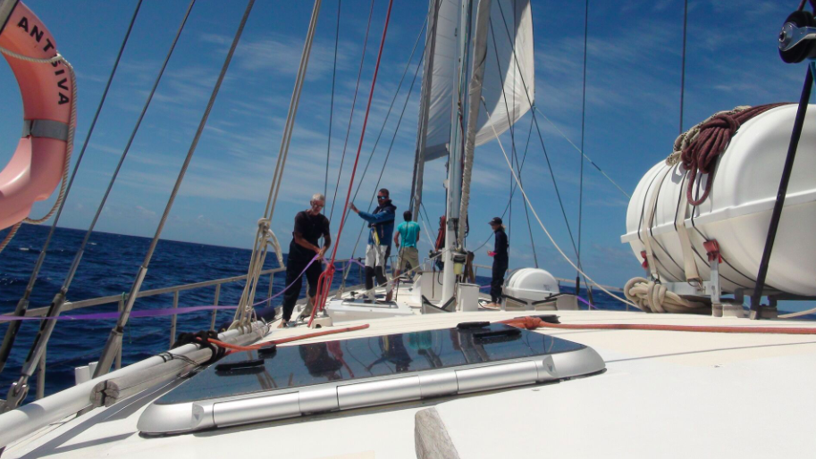aerial view of yacht bow with sailors involved in Ocean Cleanup as those travelling in Pacific asked to carry AI cameras and gps tracking devices to map garbage patch