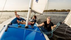 Three people on boat sailing - this is RS Aira 22, a family-friendly keelboat seen from bow