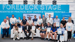 A large group of seating and standing award winners hold up their certificates at TYHA's awards ceremony in association with British Marine