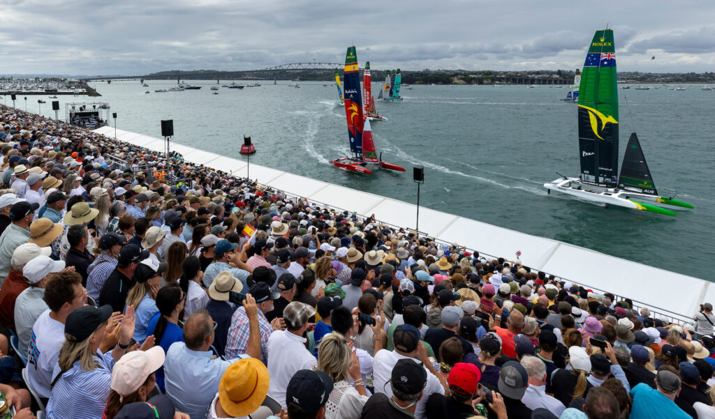 View from the grandstand as Australia SailGP Team helmed by Tom Slingsby leads the fleet on Race Day 2 of The Rolex SailGP 2025 Championship ITM New Zealand Sail Grand Prix in Auckland, New Zealand. Sunday 19 January 2025. Photo: Iain McGregor for SailGP. Handout image supplied by SailGP