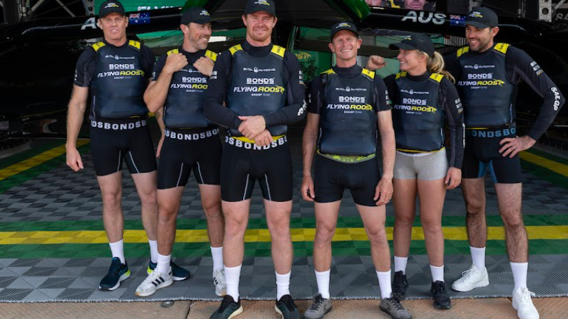 Flying Roos SailGp team model Bonds underwear, standing in a line while also wearing life jackets
