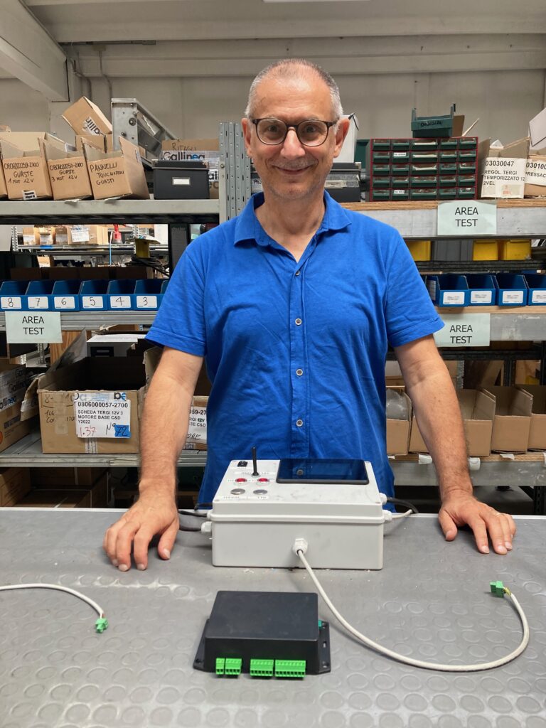 Andrea Gallinea conducting tour of his factory stands behind worktop
