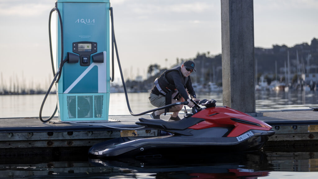 man charging PWC from electric charger
