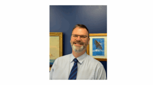 Man in tie smiles at camera